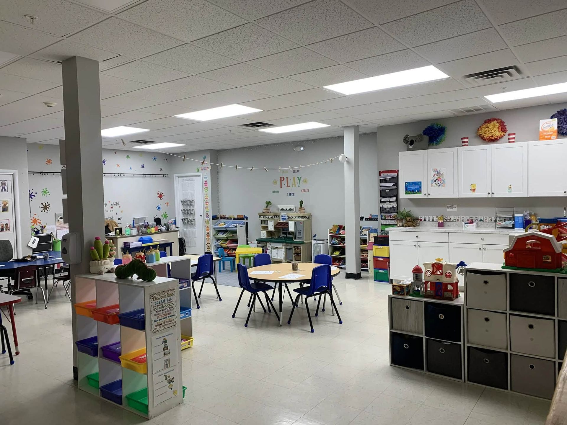 Children reading in a cozy purple classroom with inspirational wall posters and books.