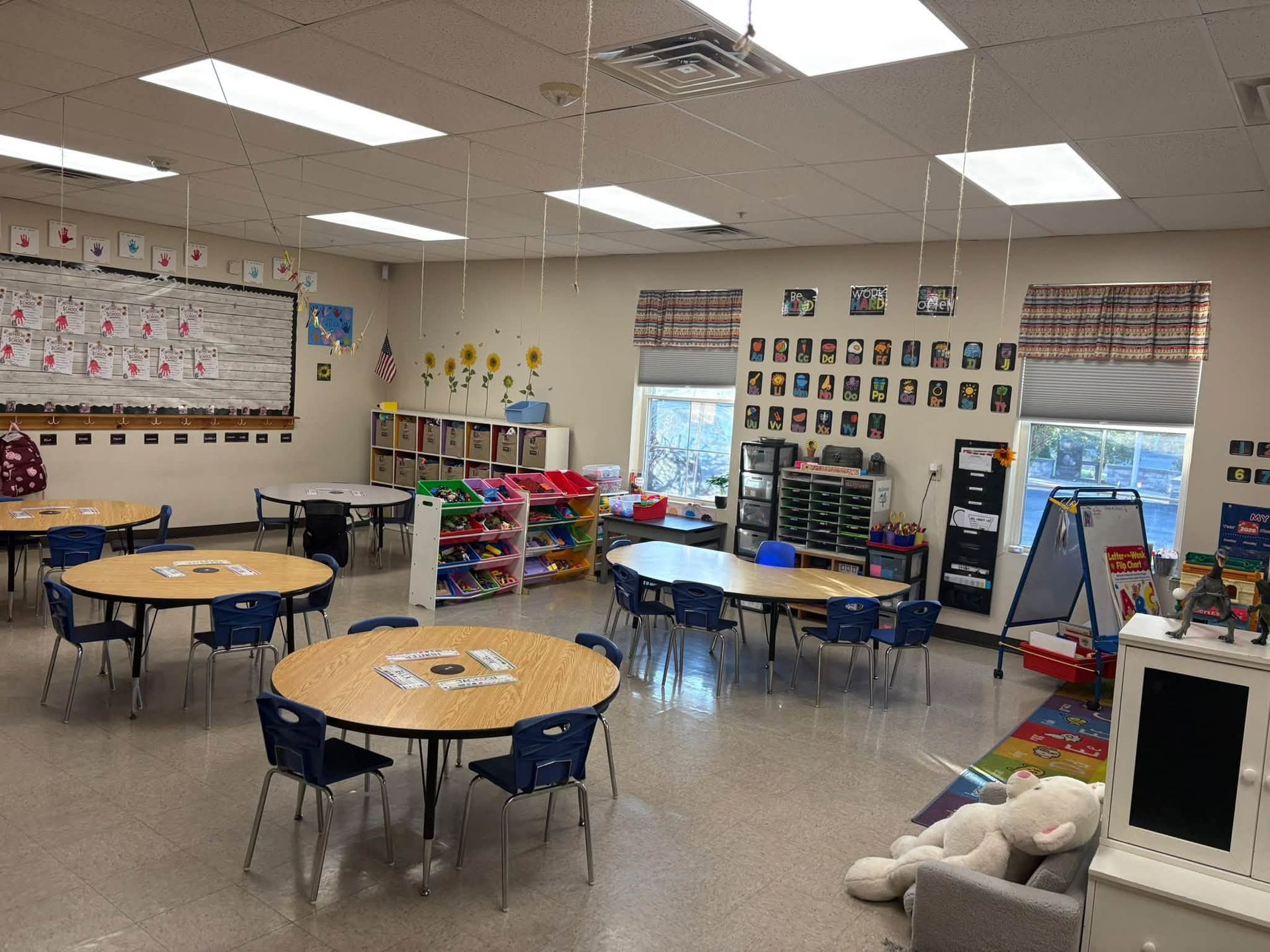 Children reading in a cozy purple classroom with inspirational wall posters and books.