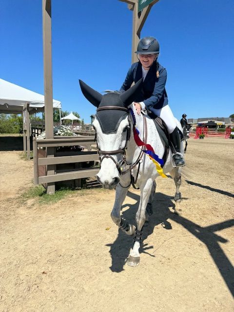 Horse and rider posing with trainer near 
