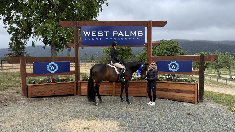 Horse and rider posing with trainer near 