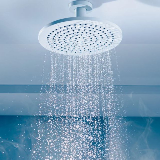 A shower head is spraying water into a bathtub.