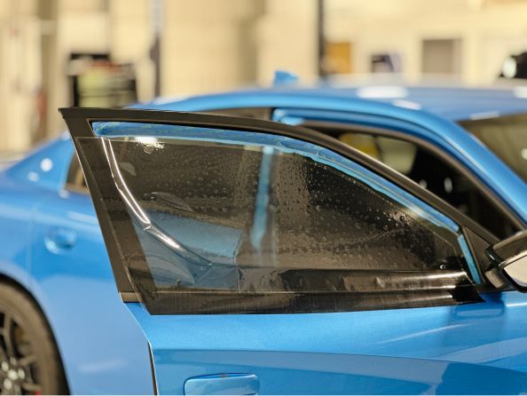 A close up of a blue car with the door open