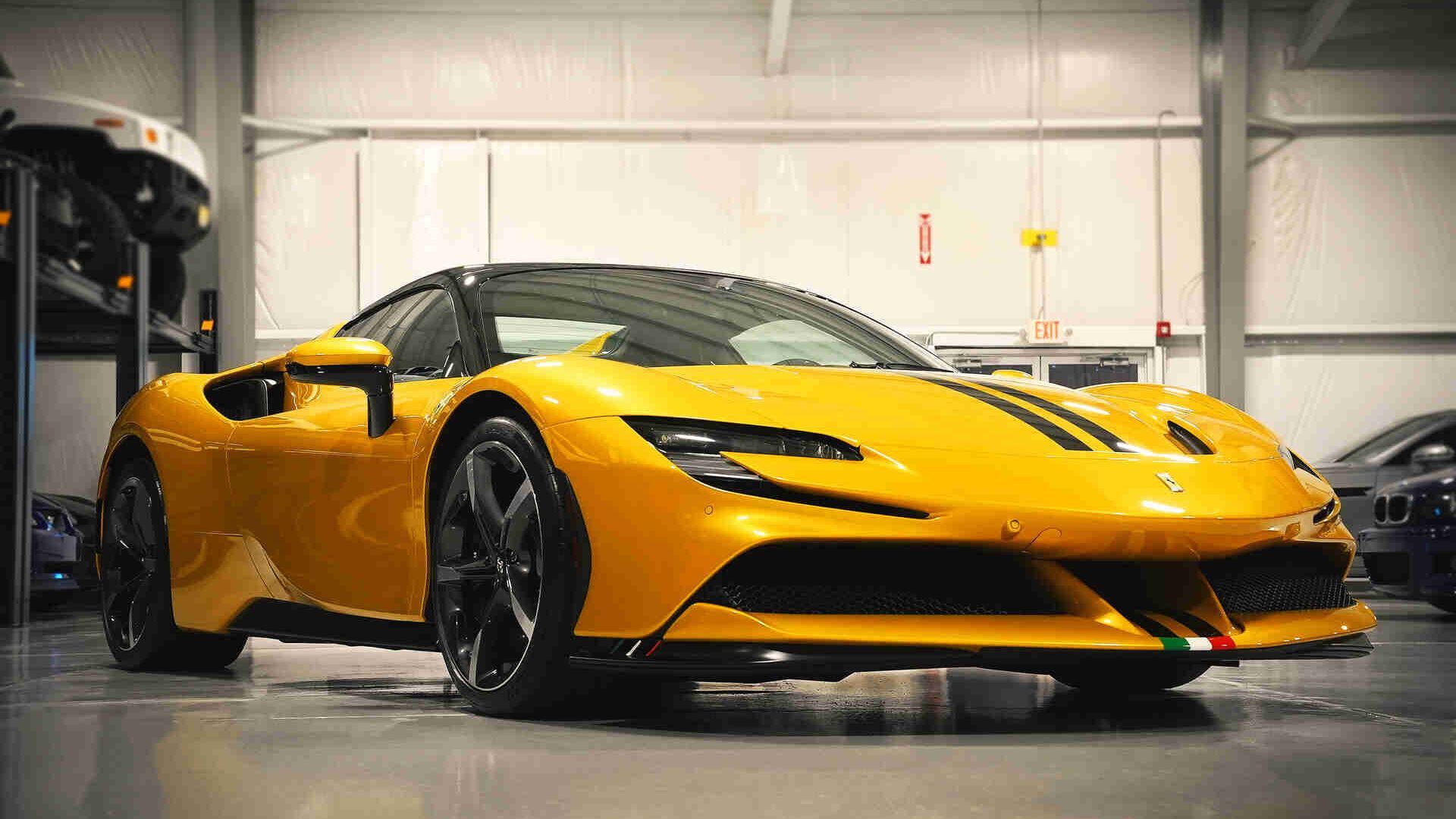 A yellow sports car is parked in a garage.