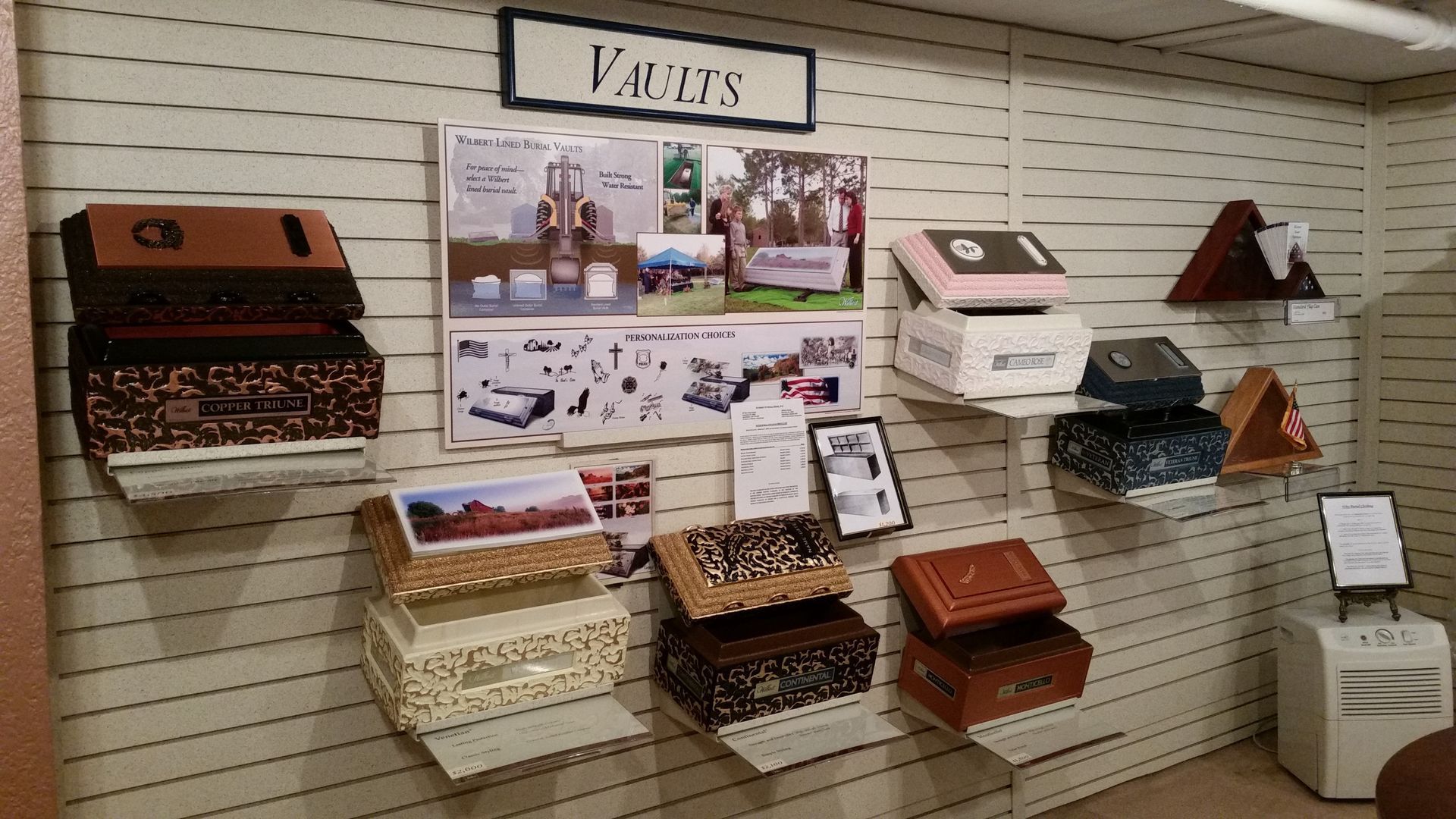 Display of decorative wall-mounted vaults and safe boxes in a store or museum exhibit.