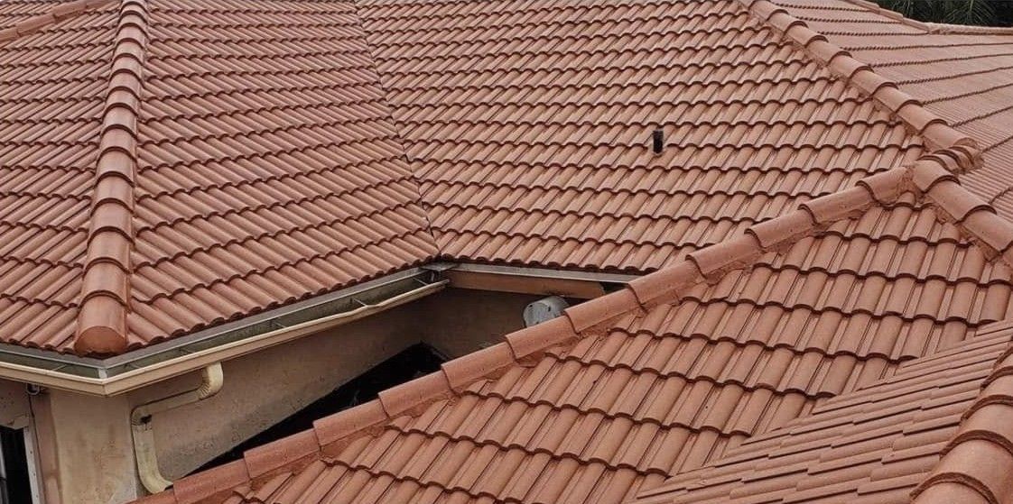 Terracotta tiled rooftops with a small visible gap between two roof sections