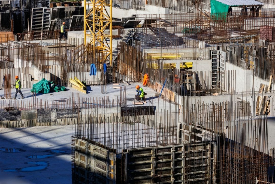 Construction workers building a concrete structure in Colorado USA under bright high-altitude sunlight