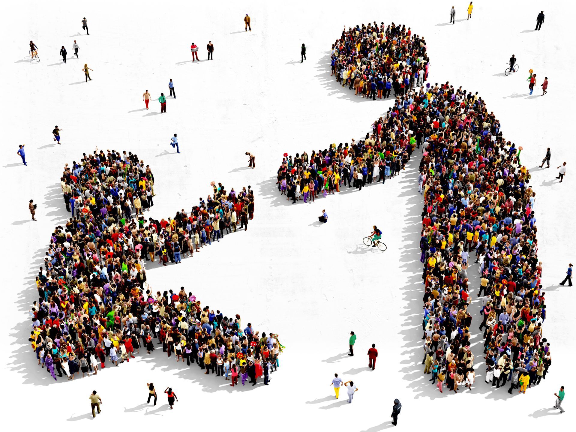 A large group of people arranged to form two figures, one standing and reaching out to help another person who is kneeling.