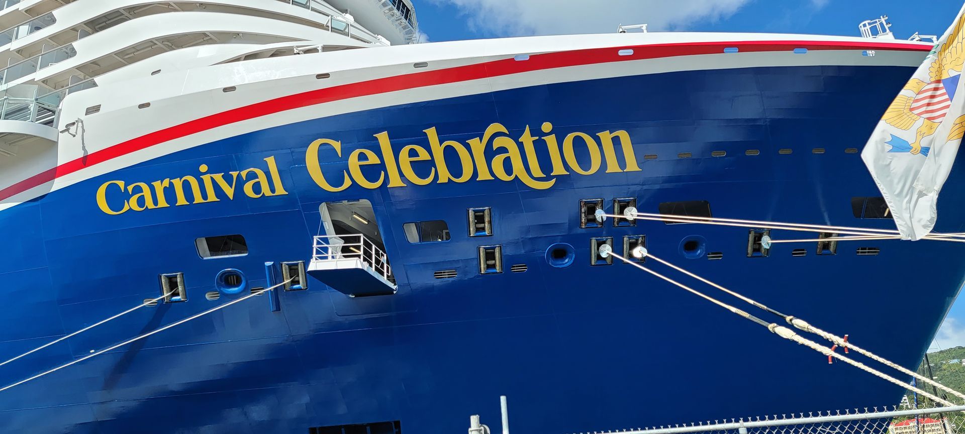 The cruise ship Carnival Celebration with blue hull, white superstructure, and gold lettering.