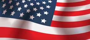 Waving American flag with red and white stripes and a blue field of white stars