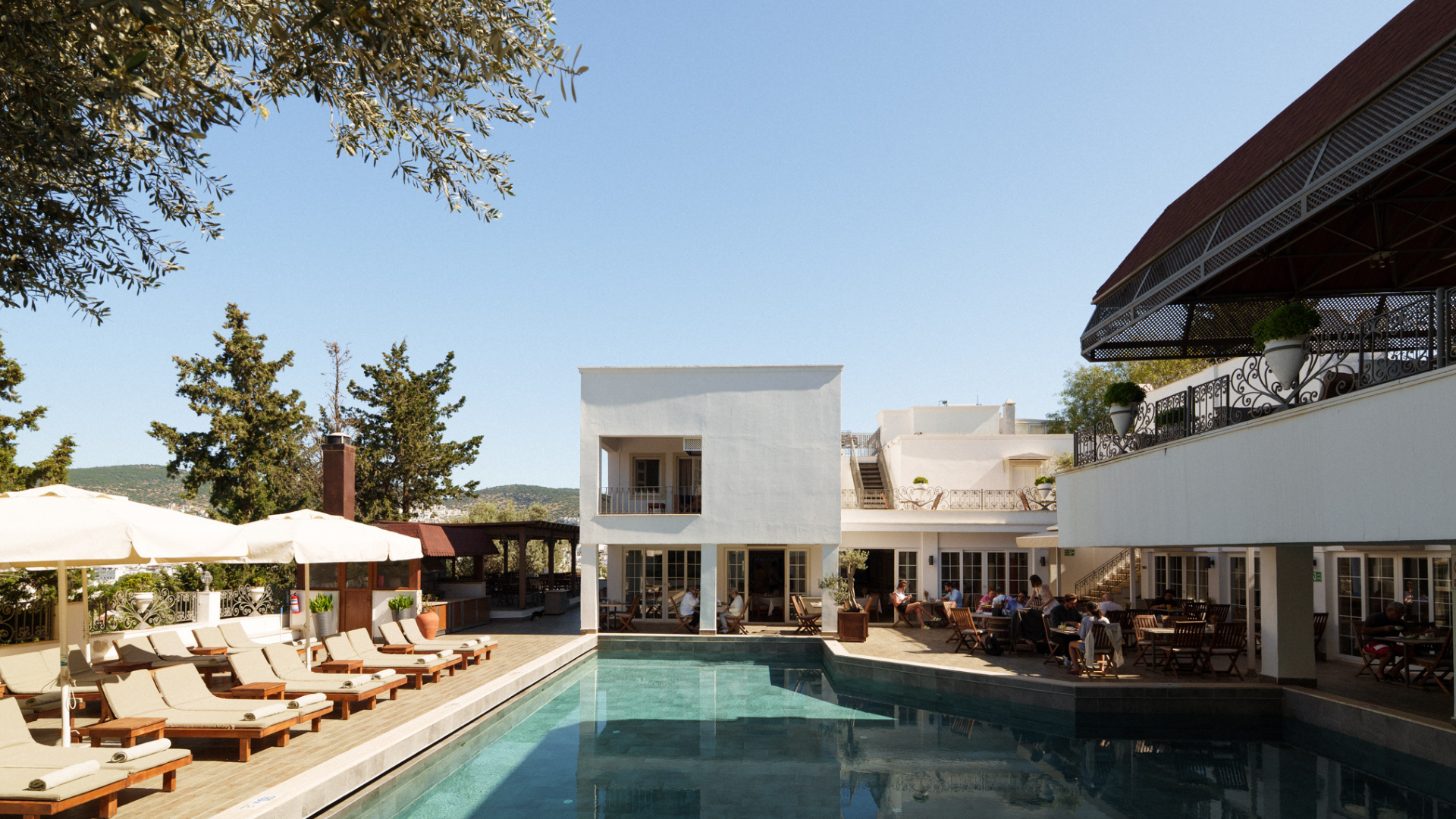 Manzara Boutique Hotel | Modern resort courtyard with a long reflecting pool, and shaded outdoor dining area