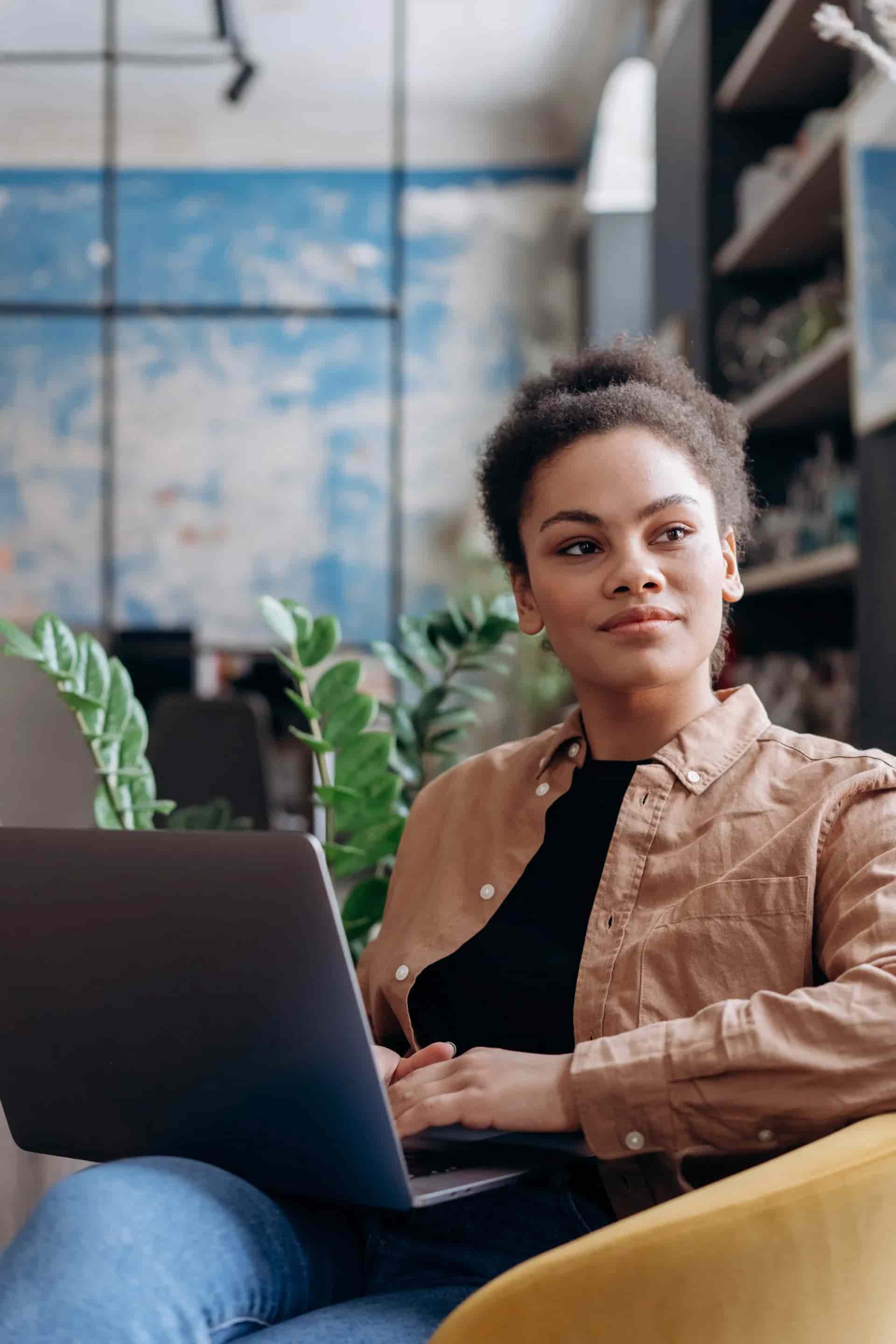A student sitting with her laptop