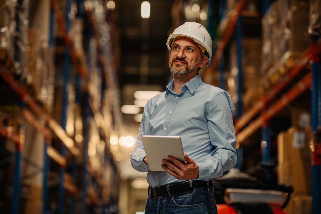 A man working in the manufacturing industry standing in a warehouse