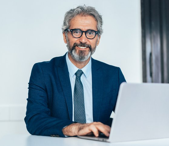 Businessman in a suit sitting with his laptop