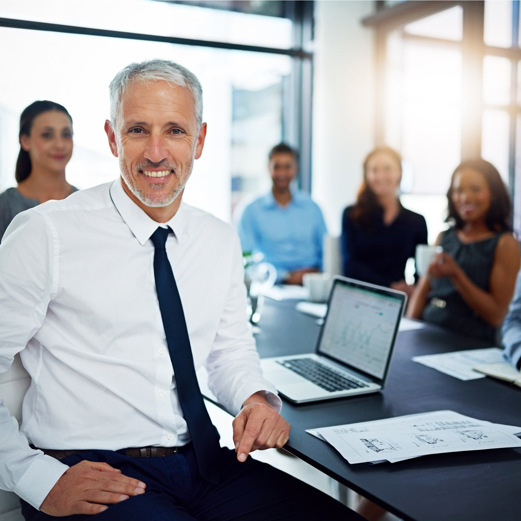 A close up of a man seated at a table during a business meeting