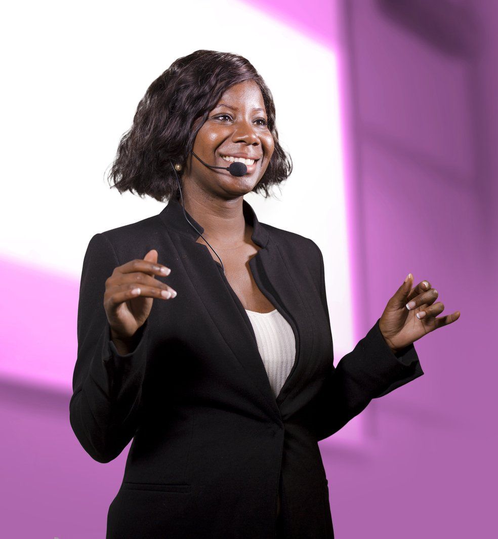A presenter smiles at the audience during a presentation