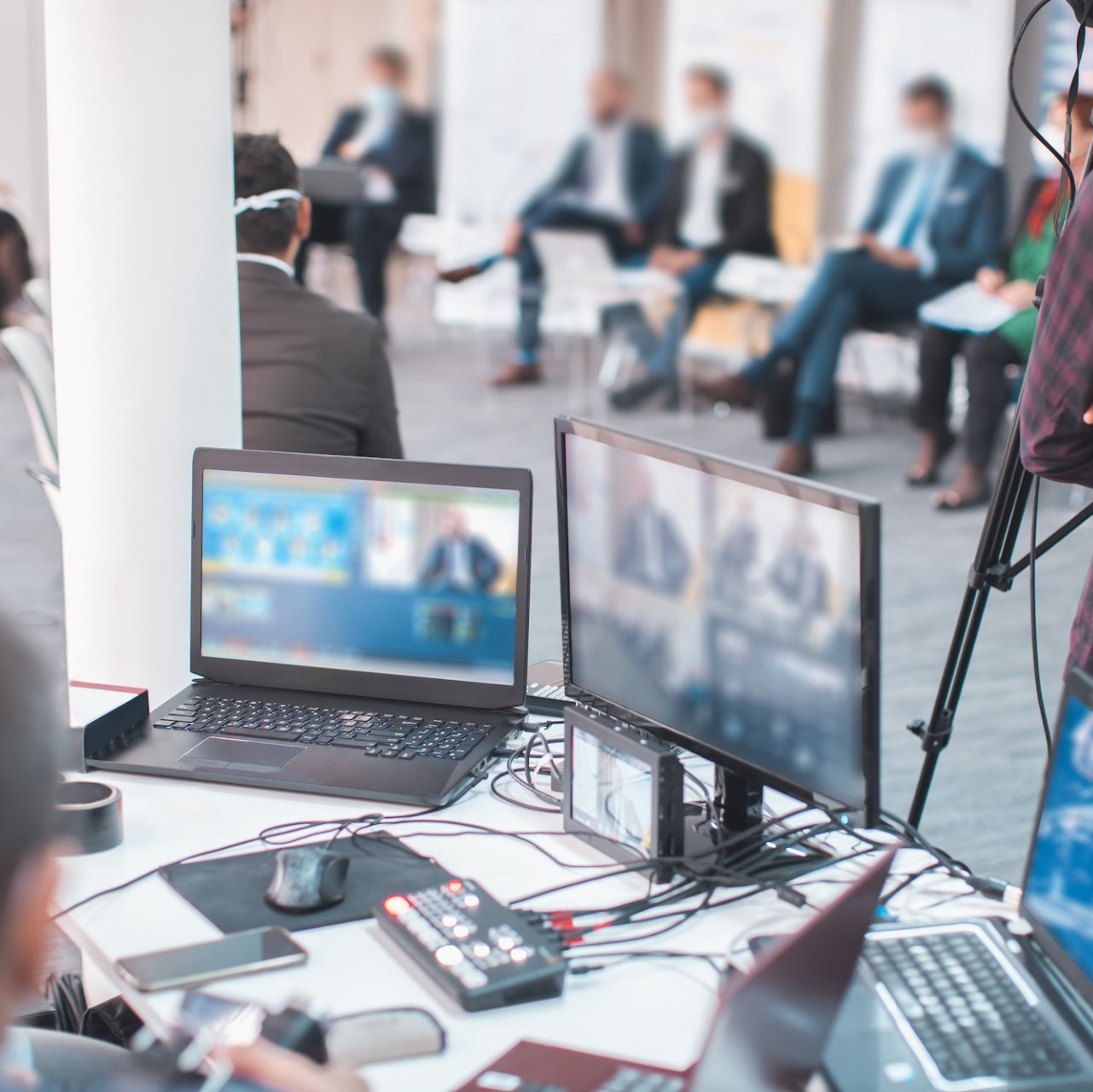 A closeup of various screens being used to produce a hybrid event