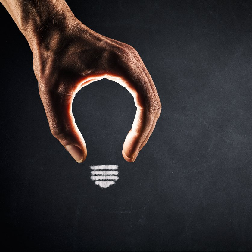 A hand forming the shape of the top part of a lightbulb