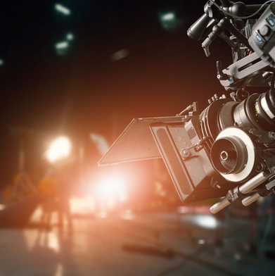 A close up of recording equipment, including a camera and spotlights