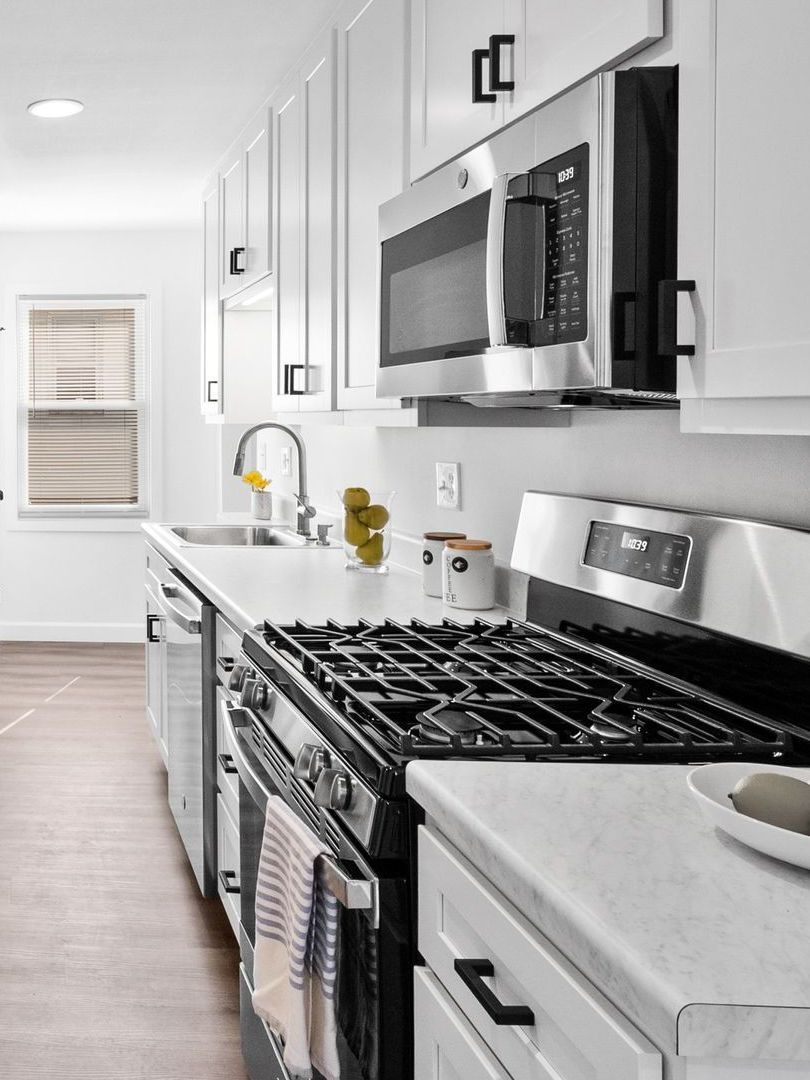 image of a clean and modern kitchen with stainless oven and microwave
