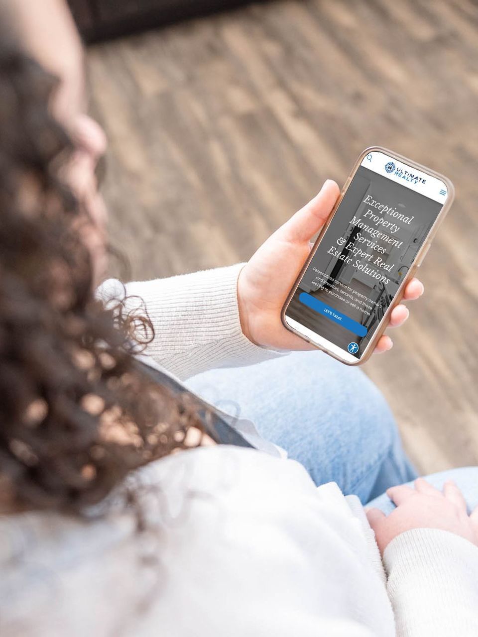 image of a woman looking at the Ultimate Realty home page