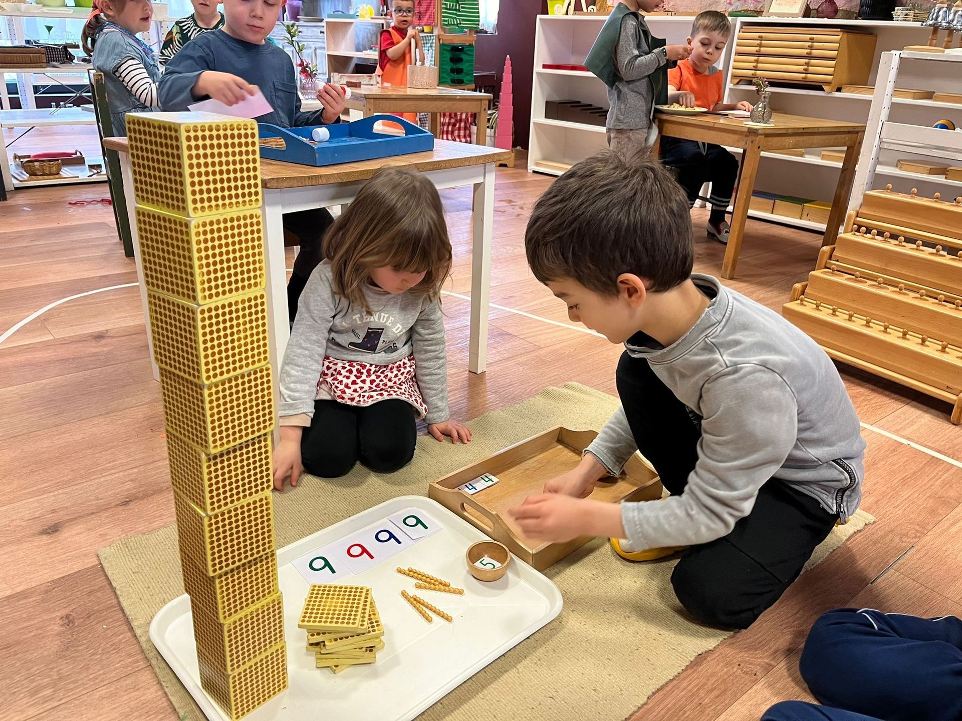 A group of children are playing with toys in a classroom.