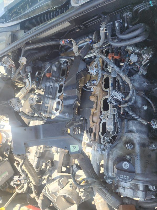 A close up of a car engine with the intake manifold removed.