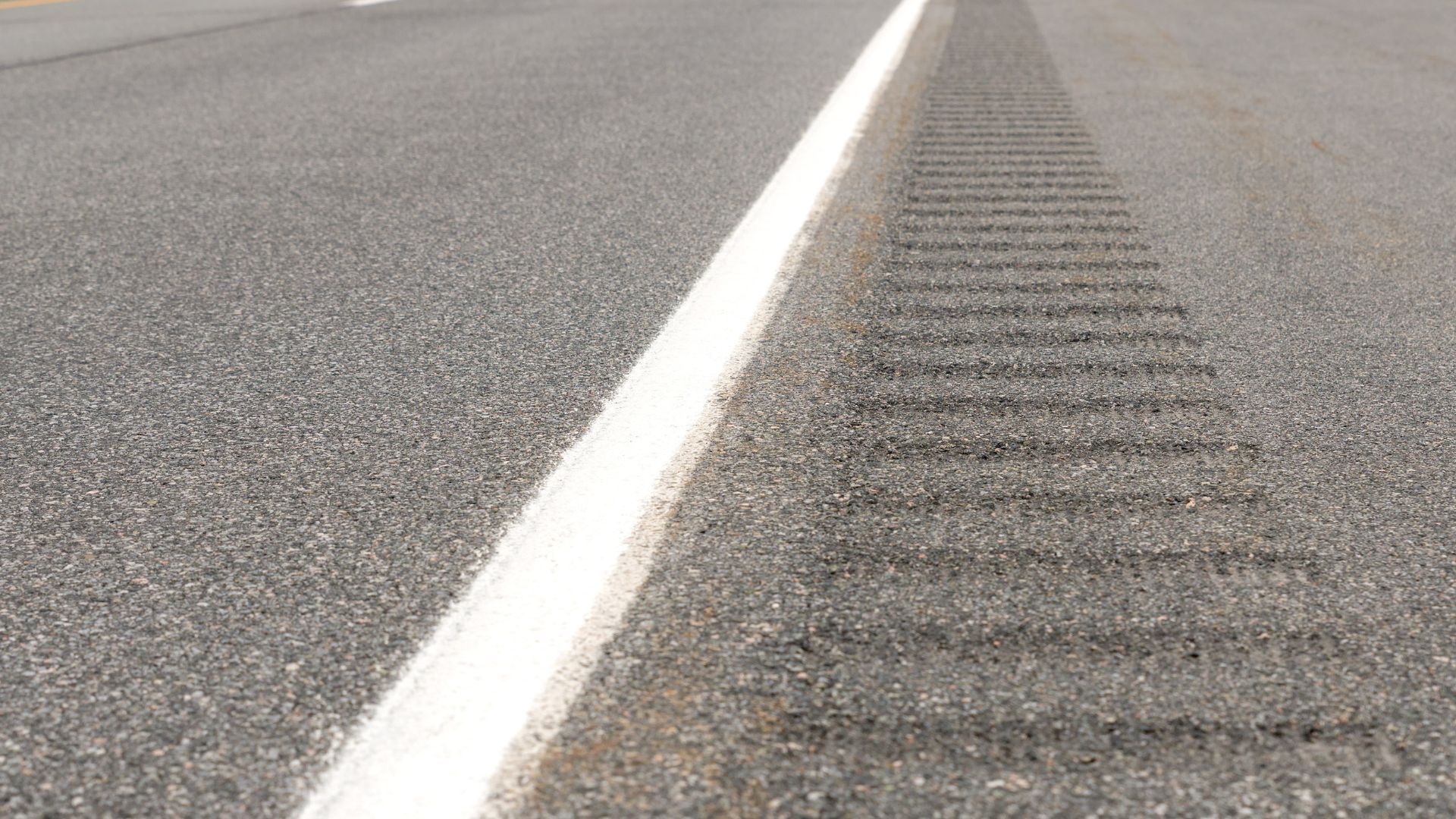 A close up of a white line on the side of a road.