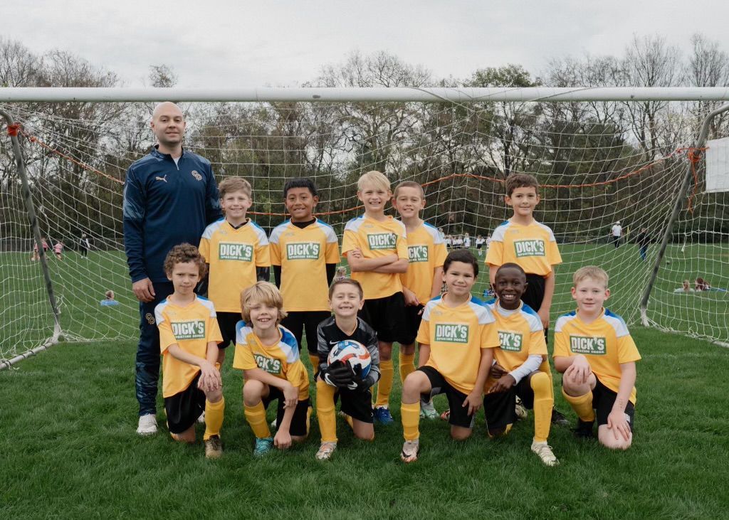 Williamson County Soccer Association soccer team posing in front of a goal
