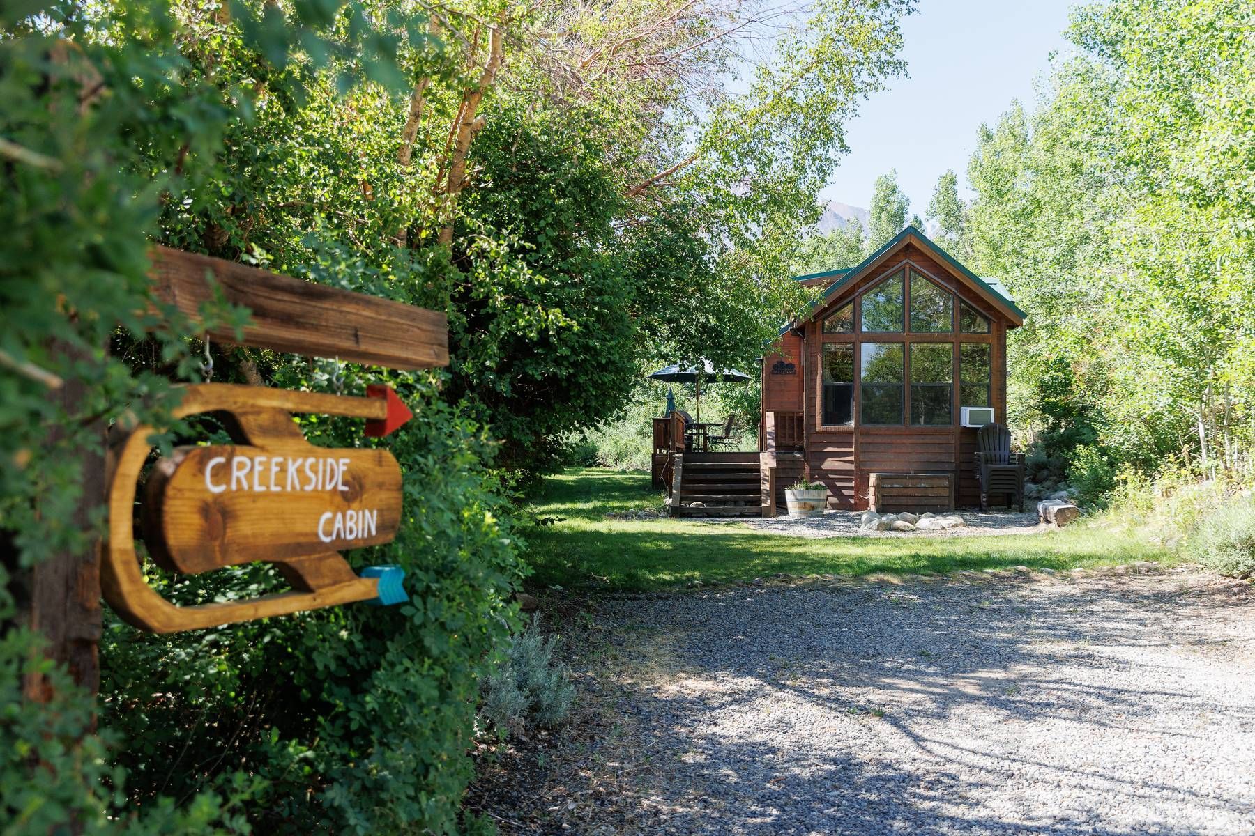 A wooden cabin with a sign in front of it.