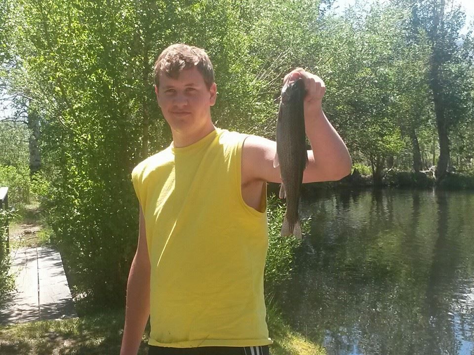 A man is fishing in a lake with a net.