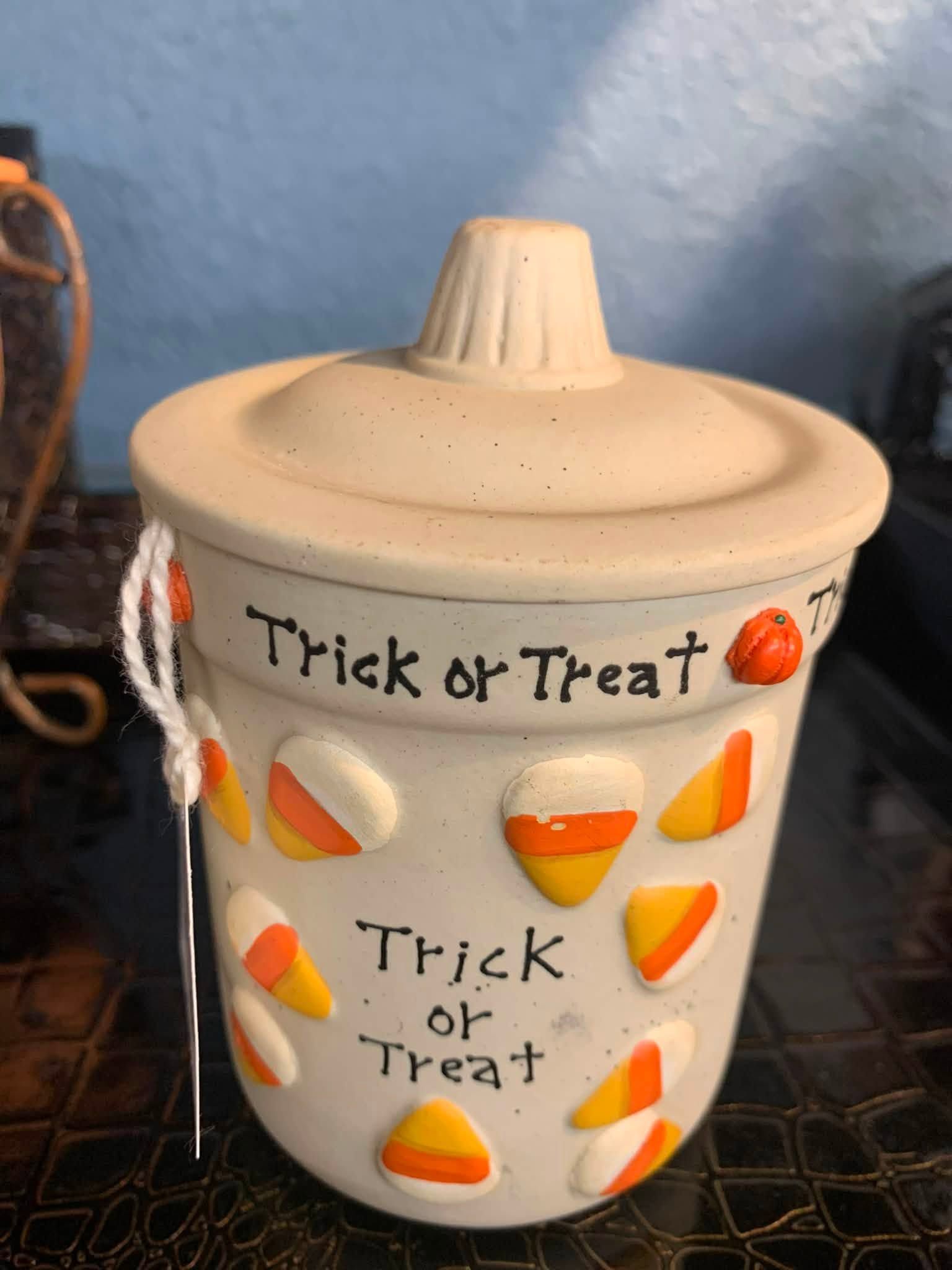 Halloween candy jar with “Trick or Treat” text and candy corn decorations