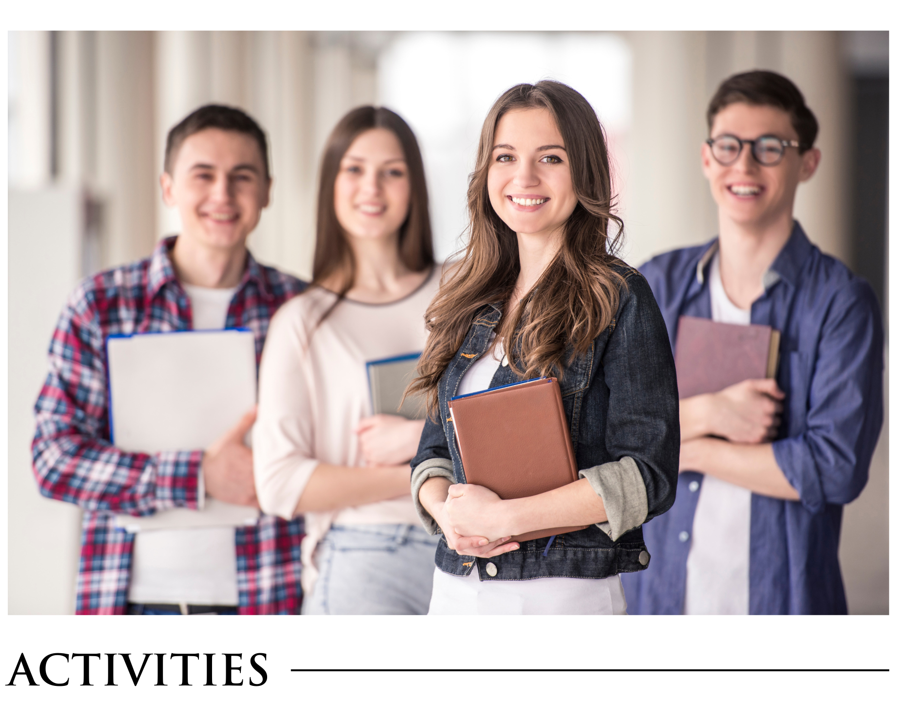 A group of young people standing next to each other holding books.