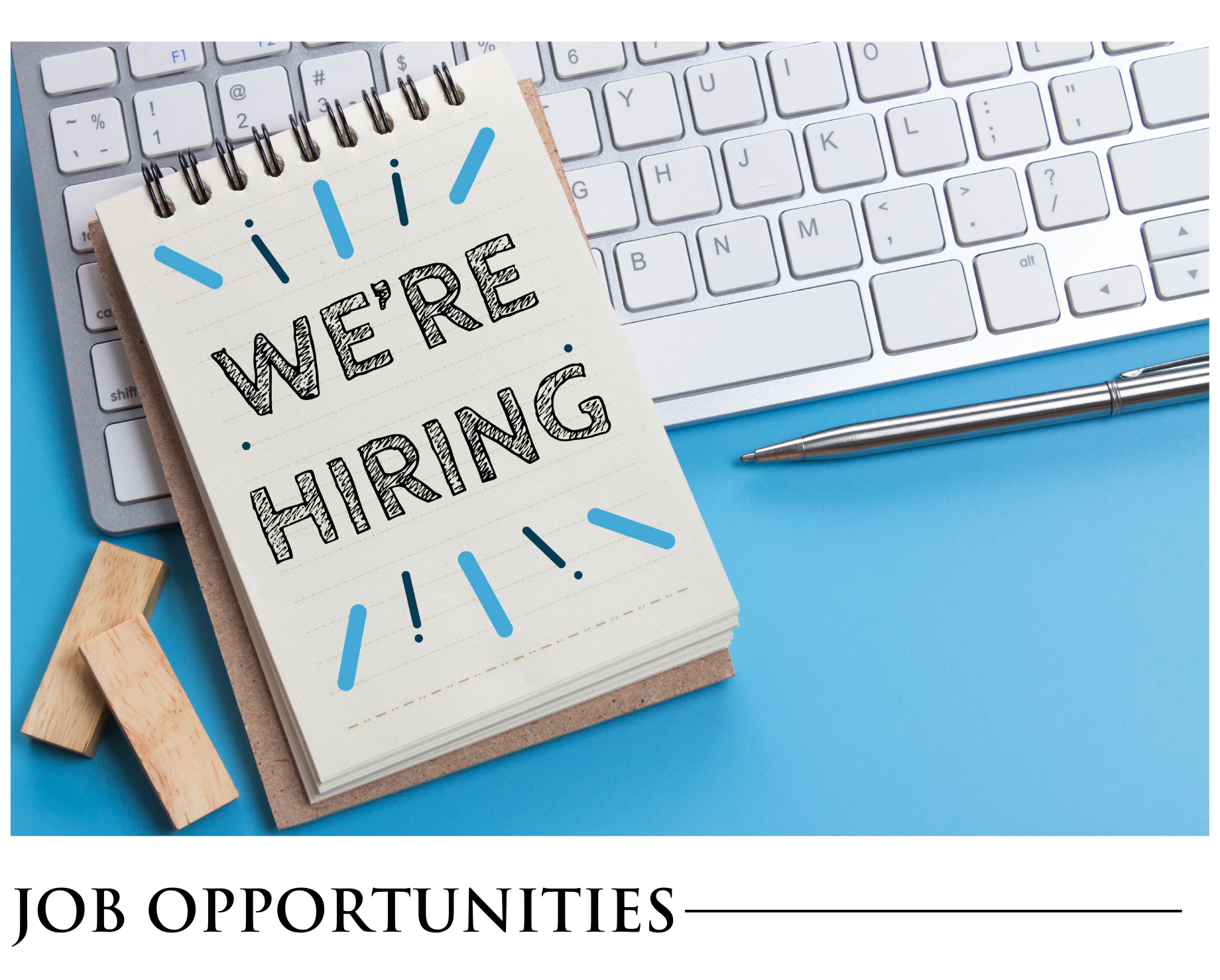 A notebook with the words `` we 're hiring '' written on it