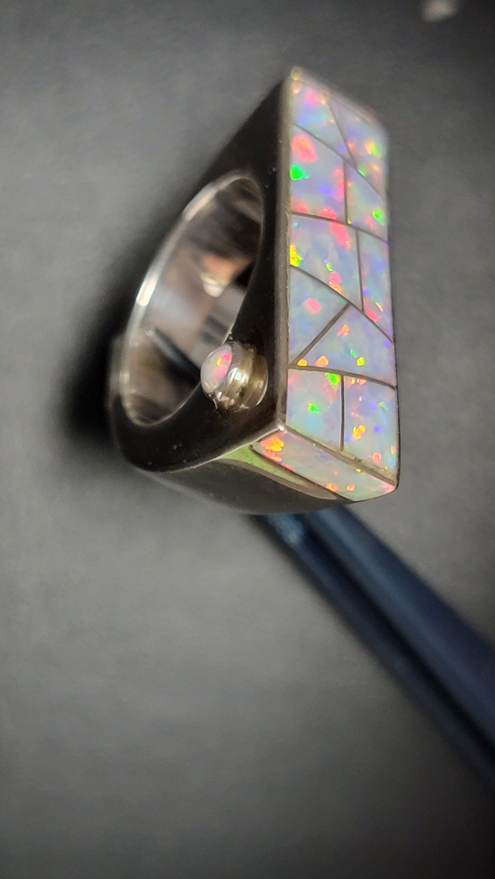 Silver ring with a large rectangular opal inlay and a small opal accent.