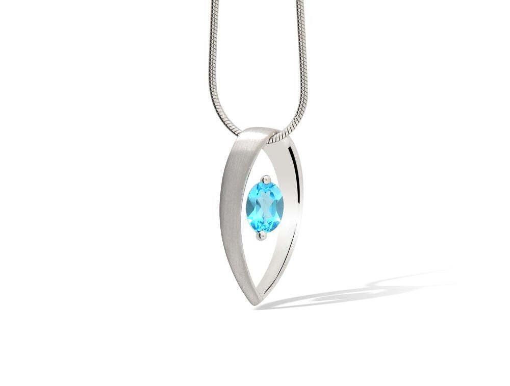 Silver pendant necklace with a blue gemstone.