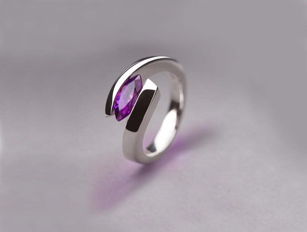 Silver ring with a marquise-cut purple amethyst gemstone.