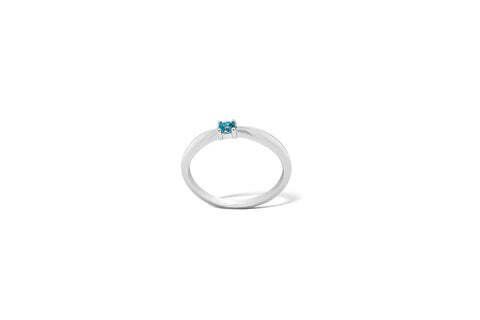 Silver ring with a small, blue gemstone.