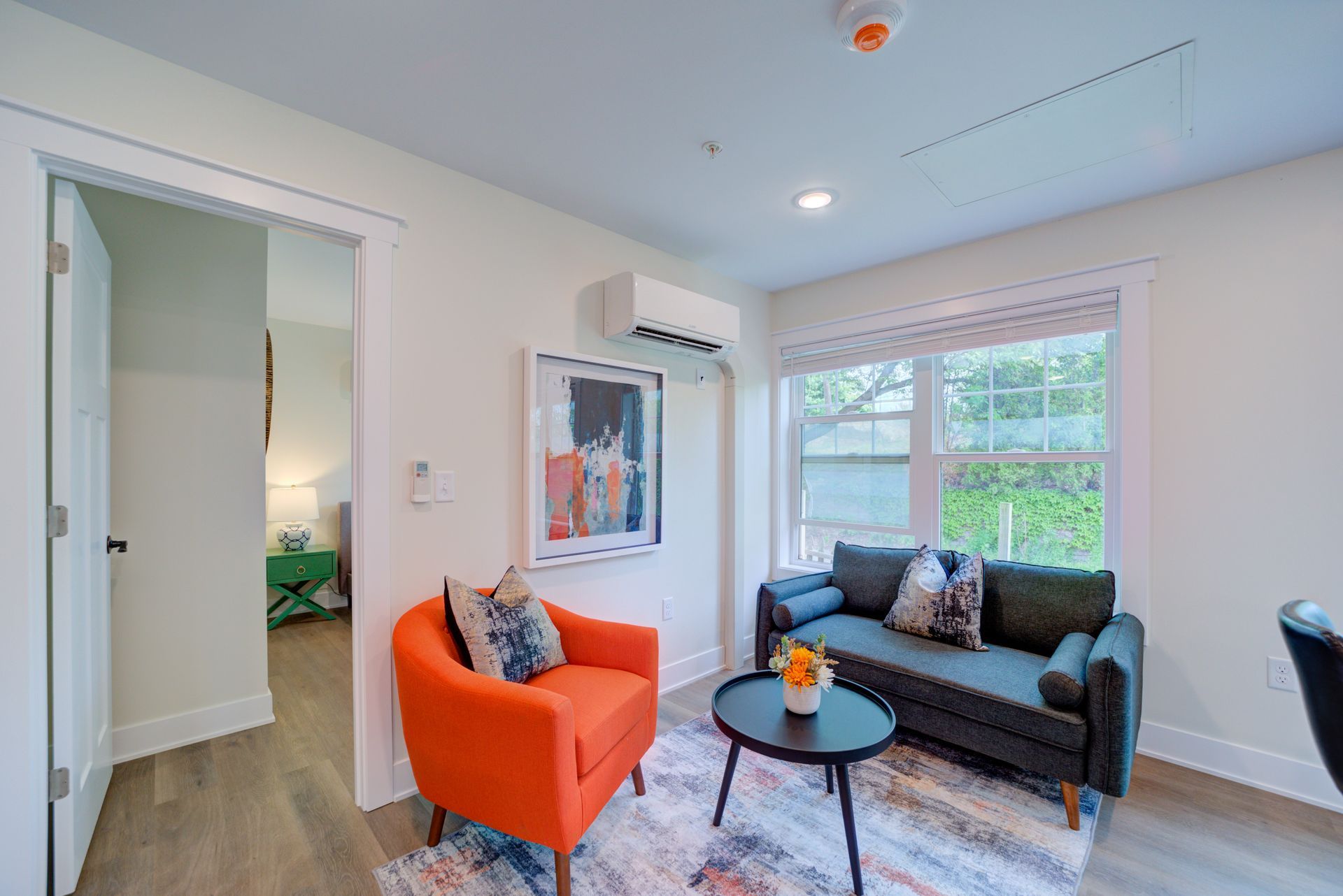 A living room with a couch , chair , and table.