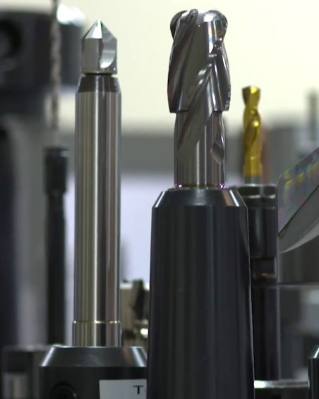 A bunch of drill bits are lined up in a row