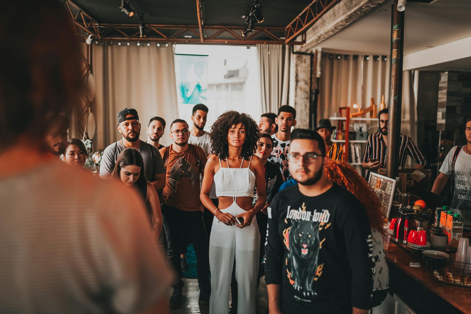 A group of people are standing in a room.
