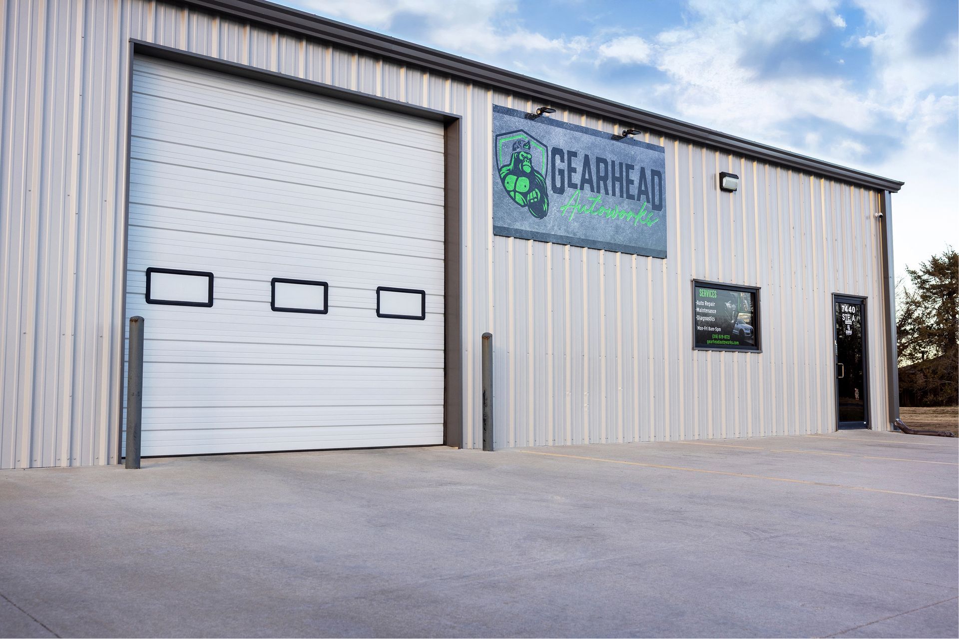 Exterior of Gearhead Offroad shop with a closed garage door and a sign. | Gearhead Autoworks