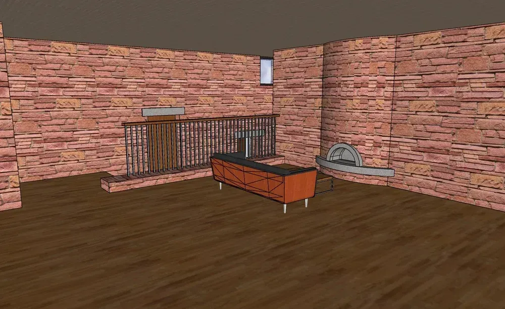 Empty brick-walled room with a brown floor, metal railing, and an orange cart beside a tray on the right
