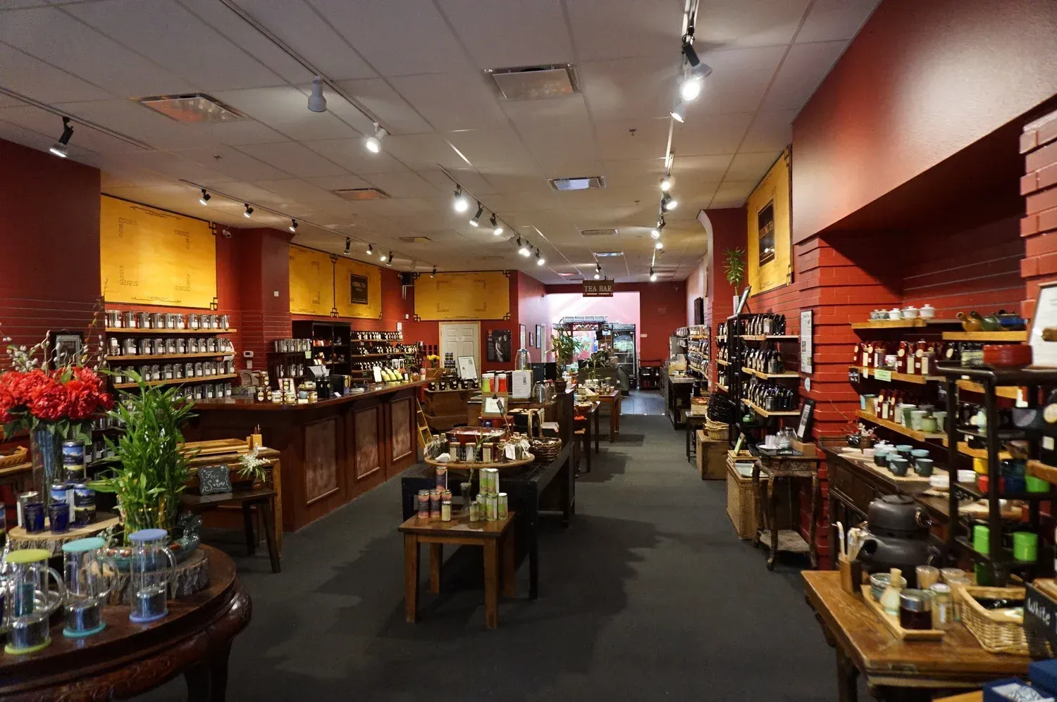 Cozy retail shop interior with wooden shelves, warm lighting, and neatly arranged jars and products
