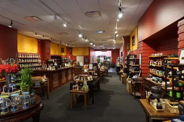 Interior of a cozy shop with shelves of jars, bottles, and small goods under warm lighting