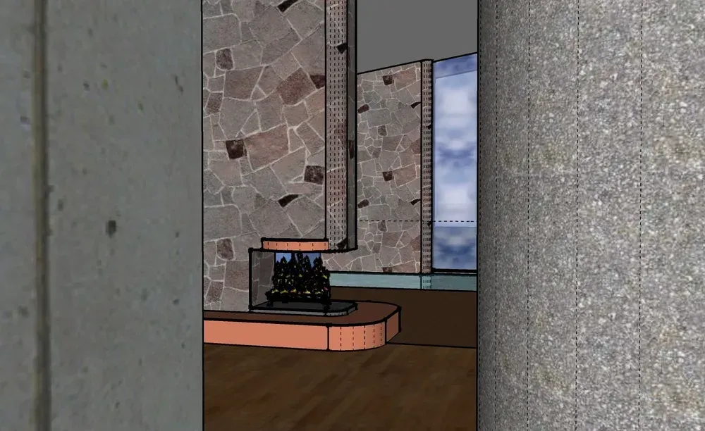 Laptop on a small table in a room with stone walls and a window.