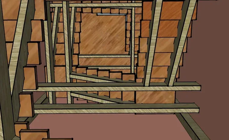 Wooden staircase and landing viewed from below, with railings and vertical beams in a brown interior.