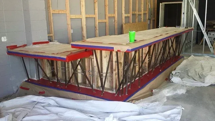 Construction scaffold wrapped in red sheeting inside a room under renovation
