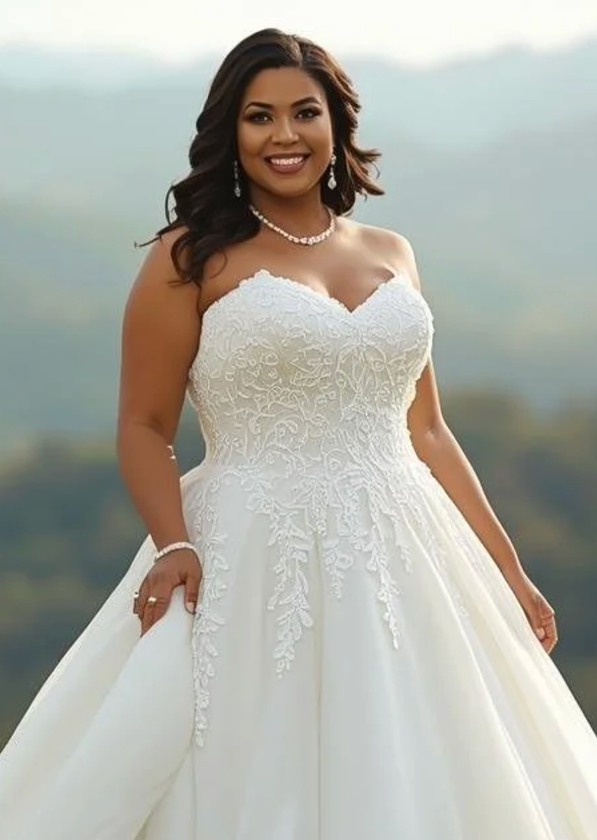 Bride in a white lace wedding gown smiling outdoors with soft mountains in the background