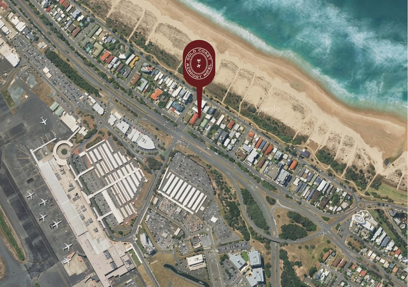 Aerial view of turquoise ocean waves meeting a sandy beach along a coastline