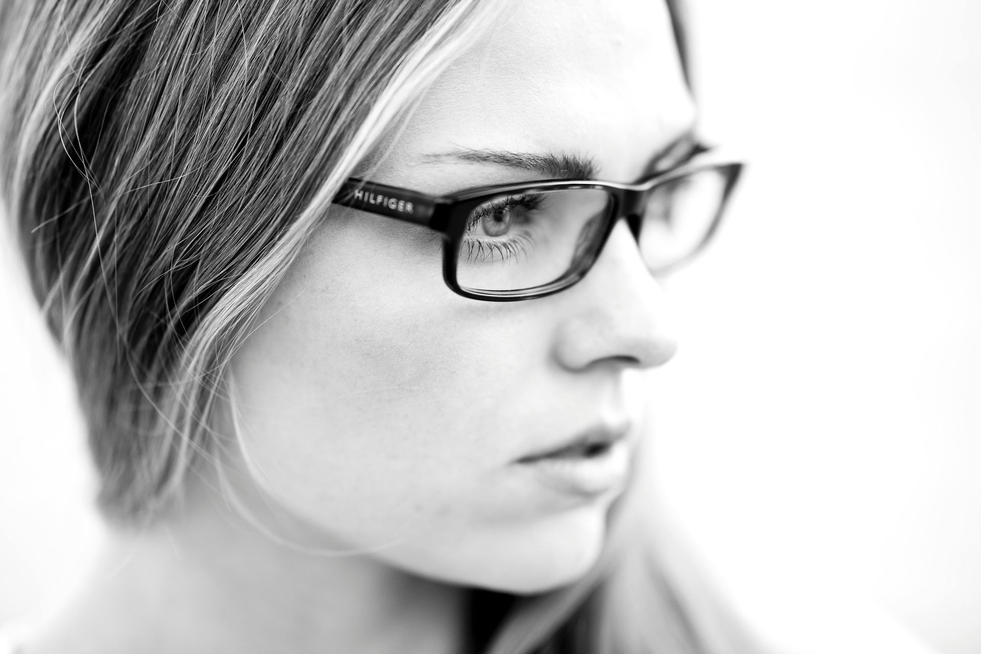 A black and white photo of a woman wearing glasses